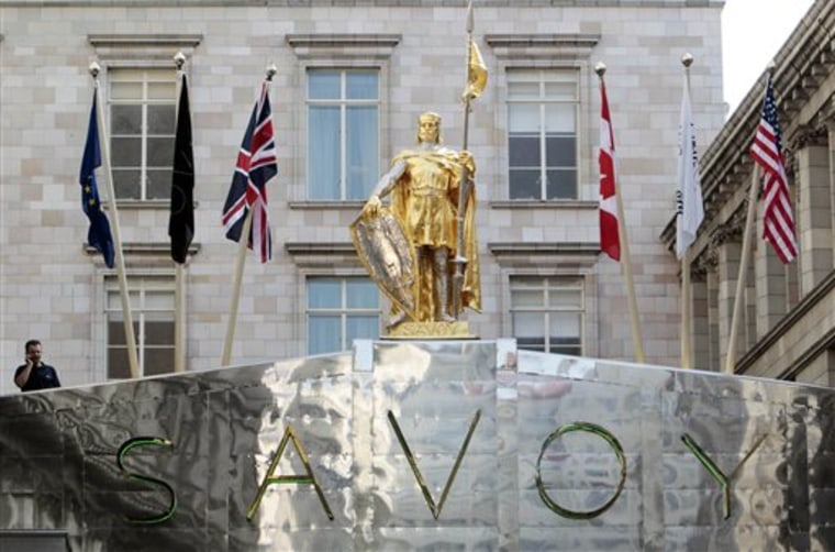 A security guard is seen on the entrance to the road that leads to the Savoy Hotel in central London on Friday. The landmark on the River Thames has been closed for three years because of a massive renovation that went over budget, but it reopens Sunday with completely renovated rooms, suites, public areas, courtyard and gardens. 
